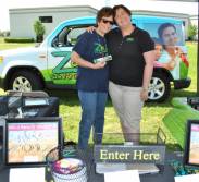 Z88.3 volunteers Karen and Michele having fun handing out stickers.