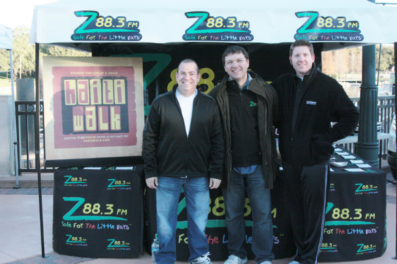 Tim Detellis and Dave Nowak from New Missions with Tim Wolf from Z88.3 greeting Z88.3 listeners and walkers as walkers register.